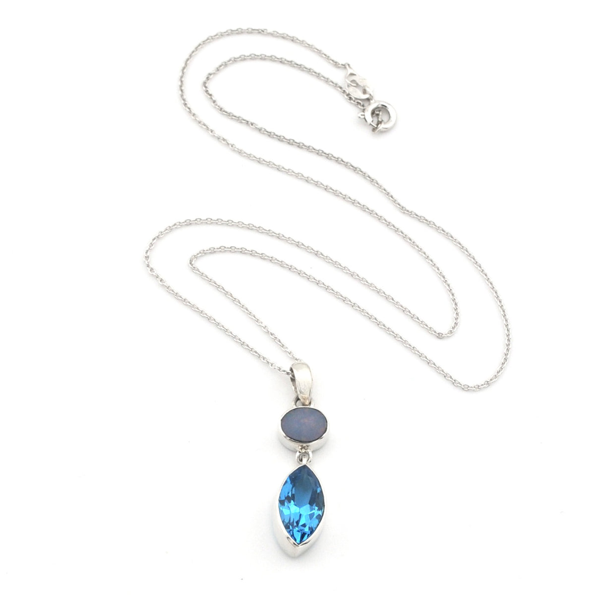 A silver necklace featuring a marquise-cut blue topaz pendant and a small oval opal stone, displayed on a clean white background.