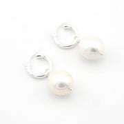 Pair of pearl hoop earrings on a white background