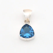 Silver pendant with a blue trillion-shaped gemstone on a white background