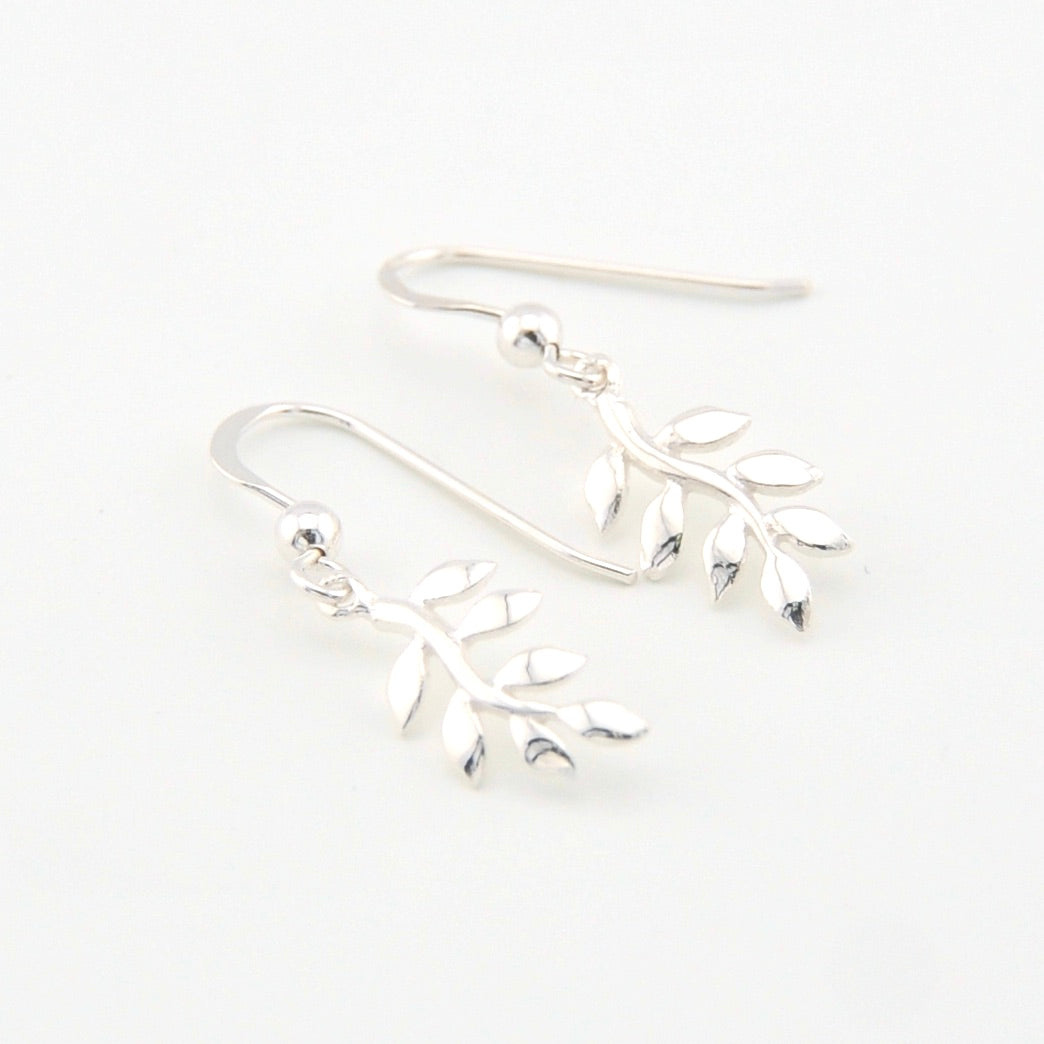 Silver branch-shaped earrings on a white background