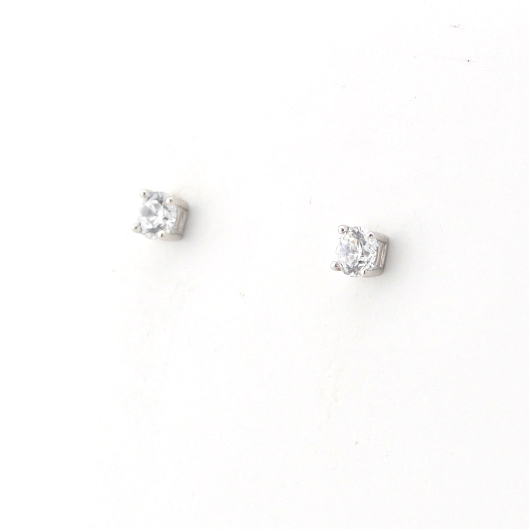 Pair of silver stud earrings with clear gemstones on a white background