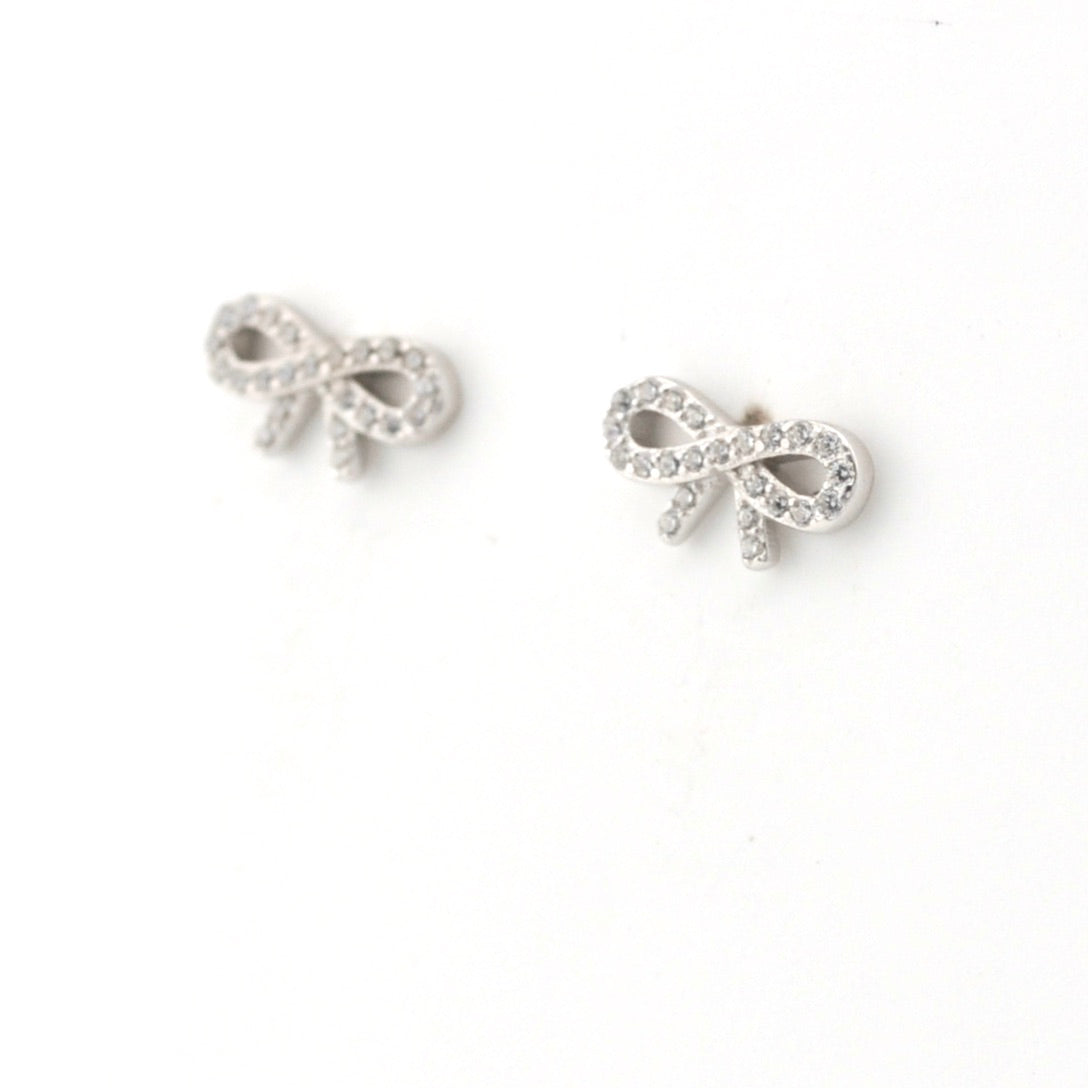 Silver bow-shaped earrings on a white background