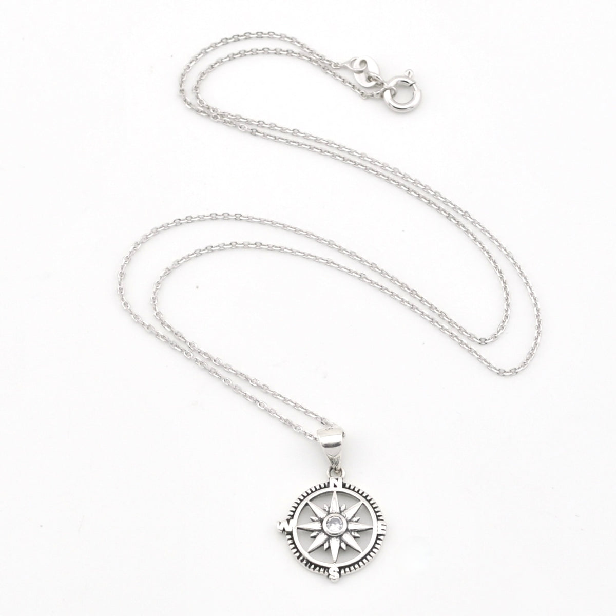 A silver compass pendant necklace on a delicate silver chain, displayed against a clean white background.