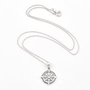 A silver compass pendant necklace on a delicate silver chain, displayed against a clean white background.