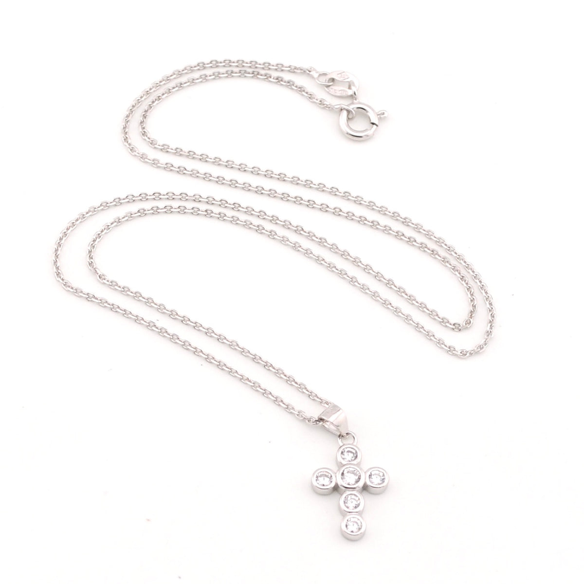 Silver necklace with a cross pendant on a white background
