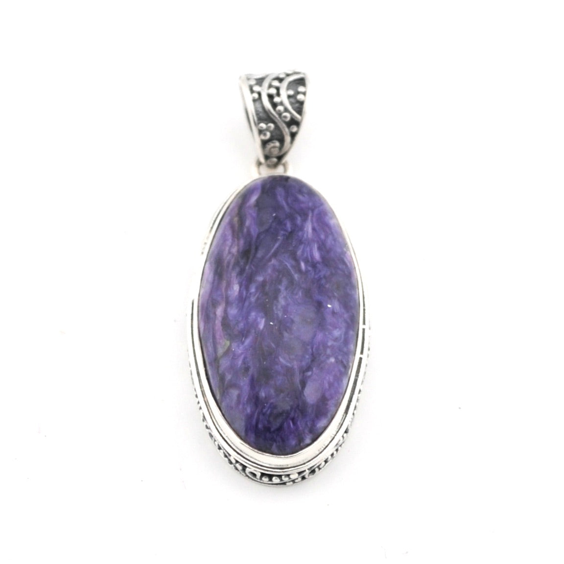 Purple stone pendant with silver setting on a white background