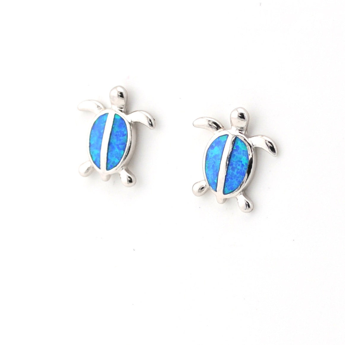Turtle-shaped earrings with blue gemstones on a white background