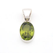 Green gemstone pendant on a white background