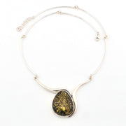 Necklace with a large teardrop-shaped green stone pendant on a white background