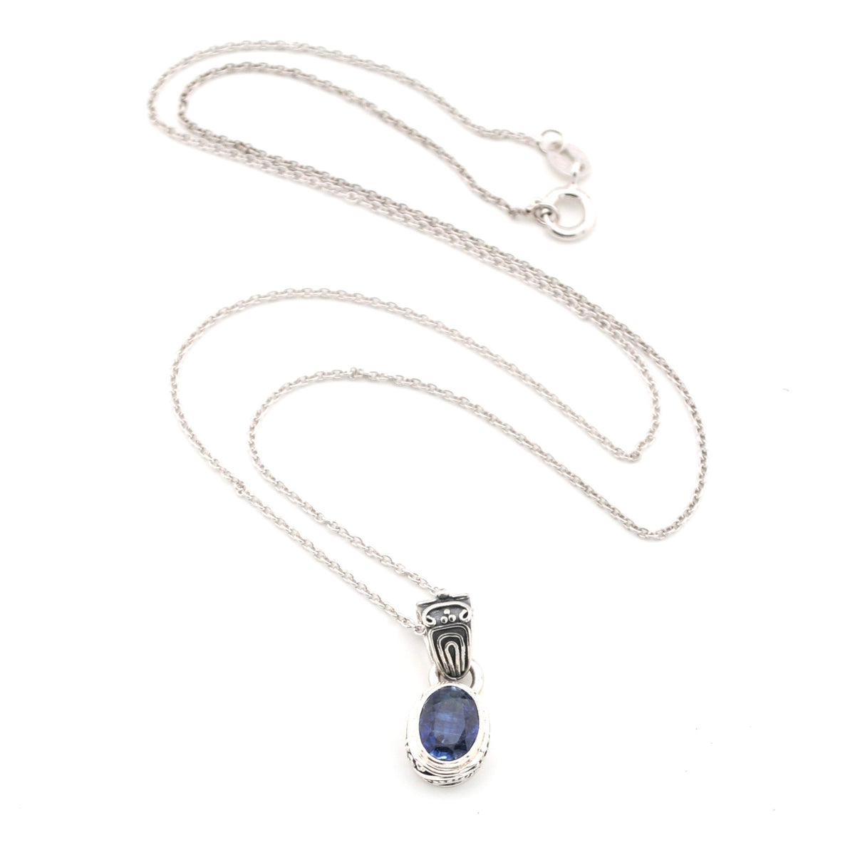 Silver necklace with a blue kyanite pendant on a white background