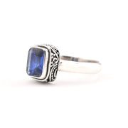 Silver ring with a blue kyanite gemstone on a white background