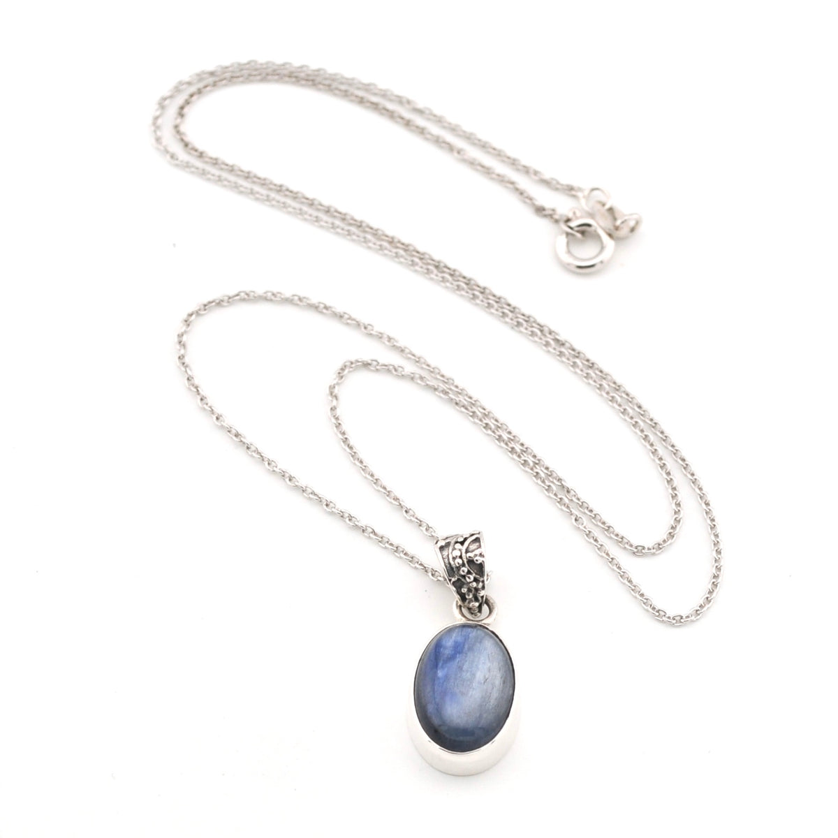 Necklace with a blue kyanite oval pendant on a white background