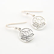 Silver lotus flower earrings on a white background