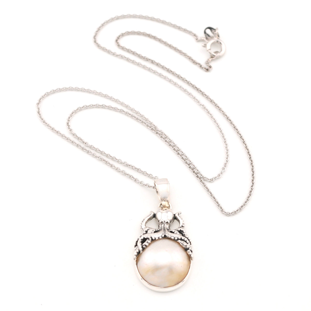 Silver pearl pendant with octopus on white background