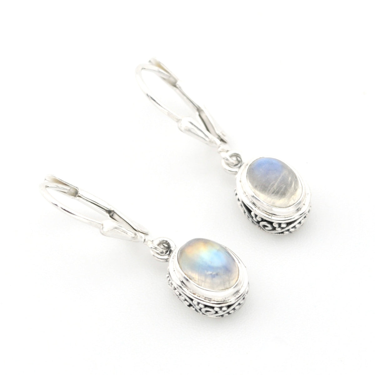 Silver earrings with rainbow moonstone stones on a white background