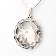 Silver pendant with wolf design and gemstones on a white background
