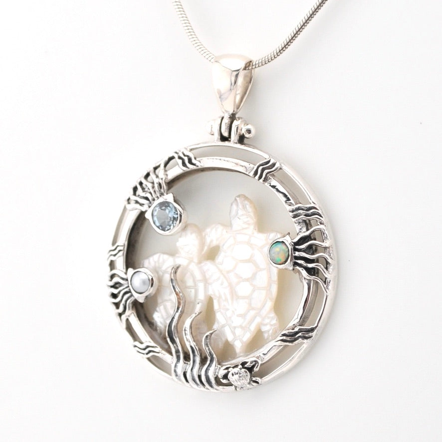Silver pendant with wolf design and gemstones on a white background