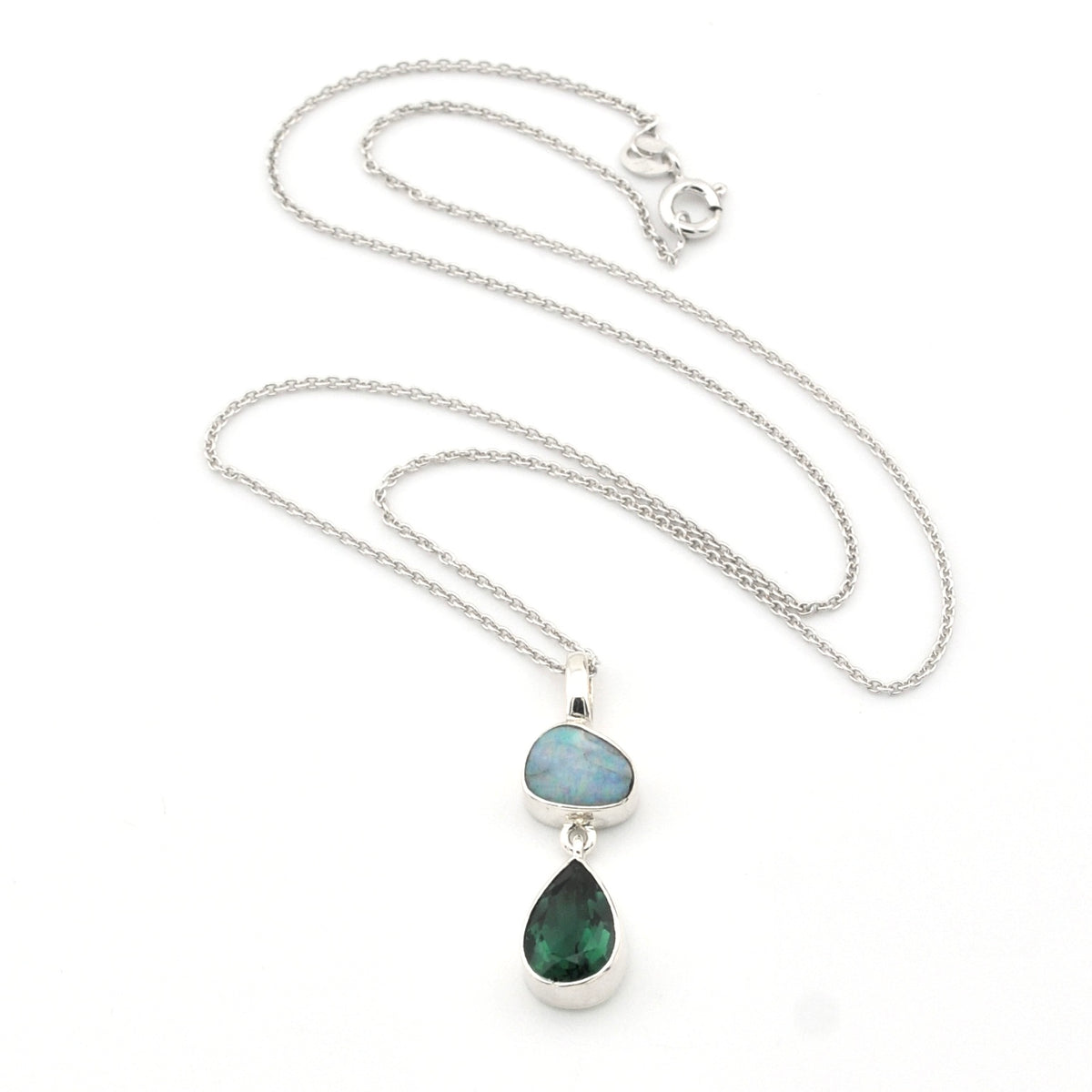 Necklace with two teardrop-shaped gemstones on a white background