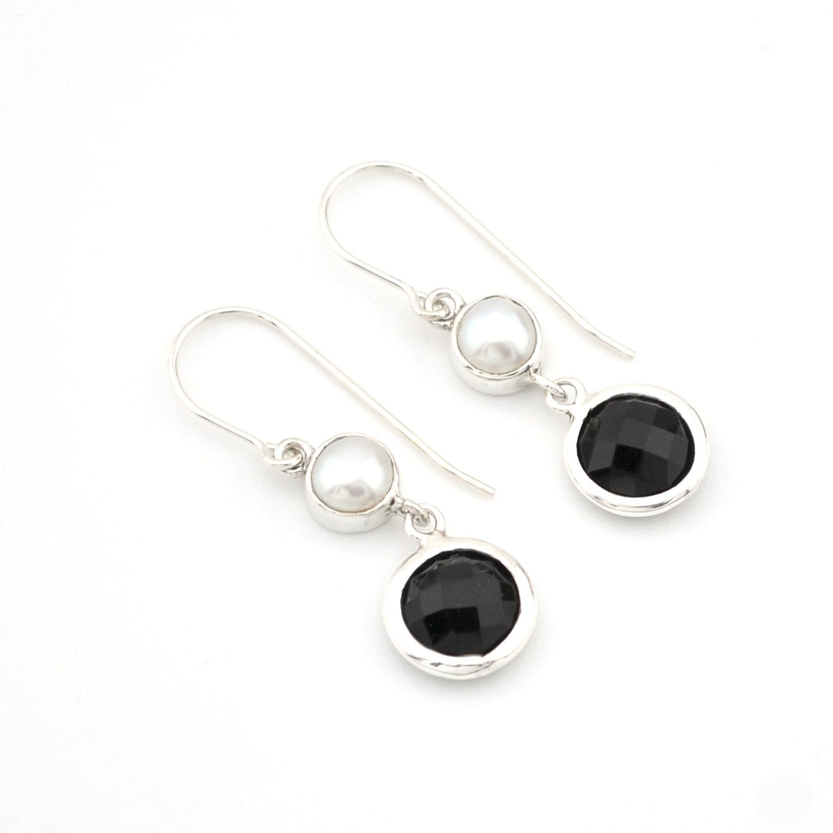 Pair of earrings with black and white gemstones on a white background