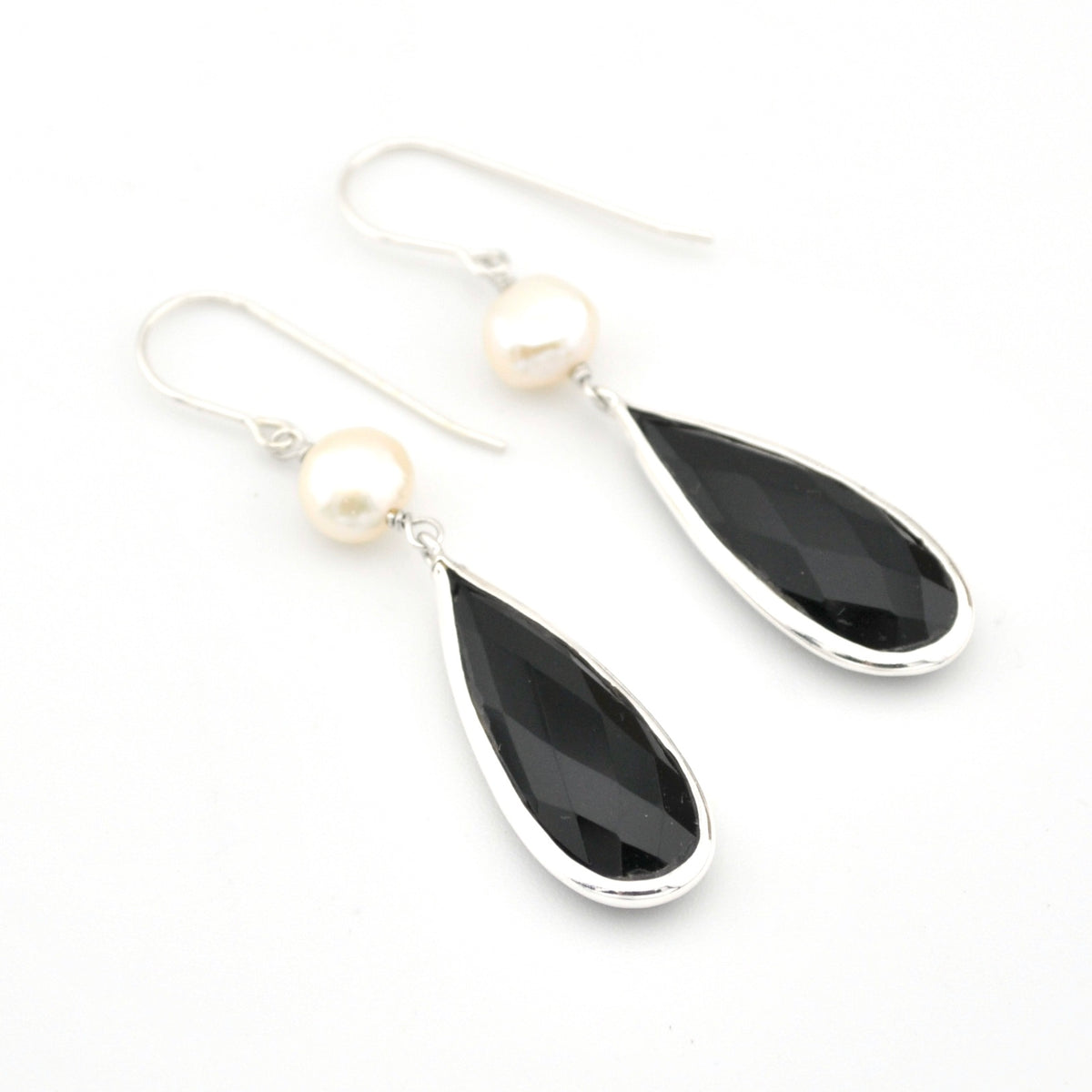 Black teardrop earrings with pearl accents on a white background