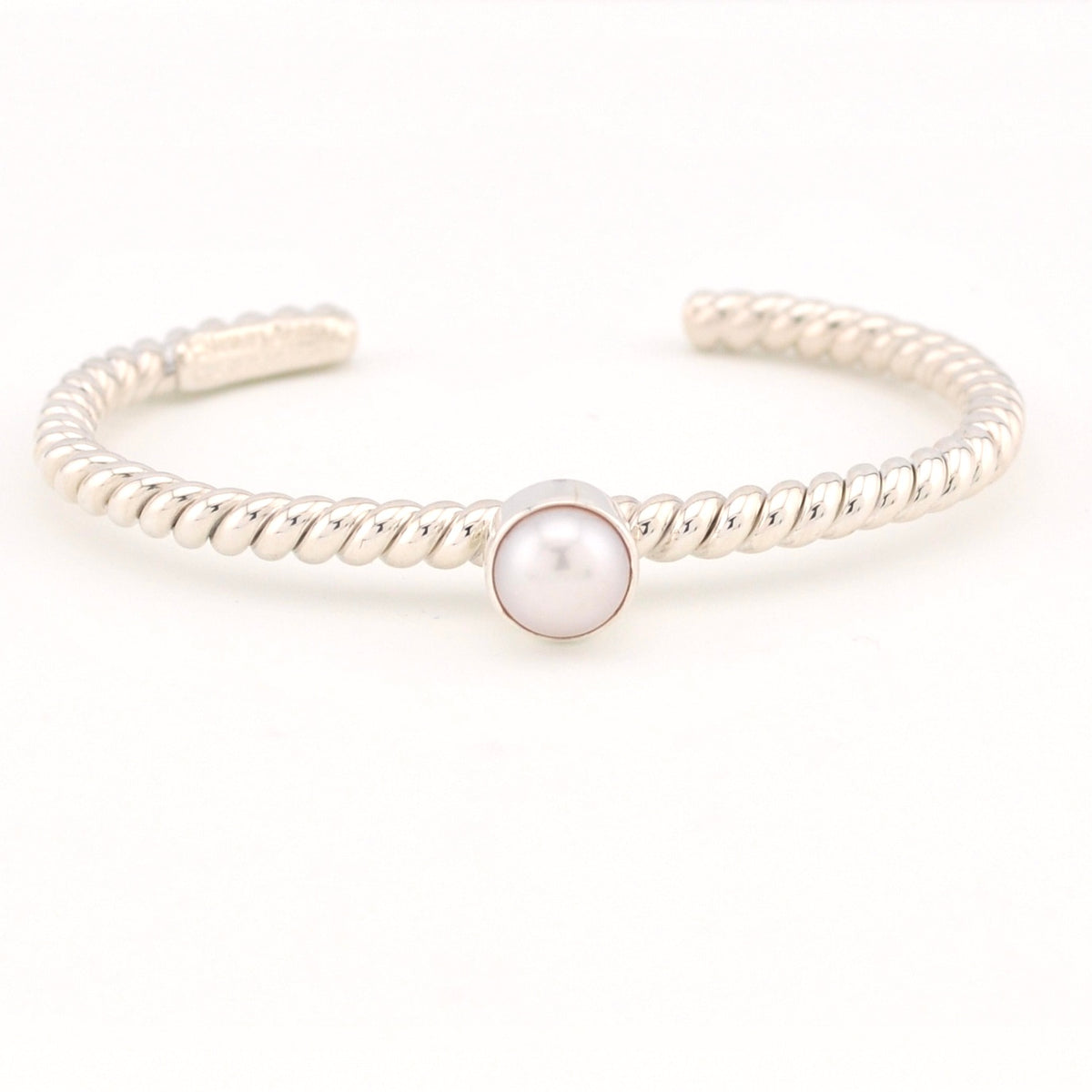 Silver bracelet with a pearl on a white background