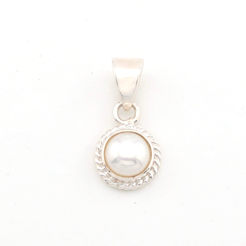 Pearl pendant with silver setting on a white background