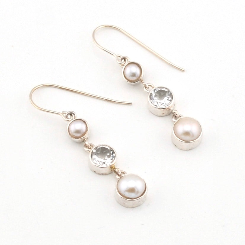Pair of pearl and topaz drop earrings on a white background