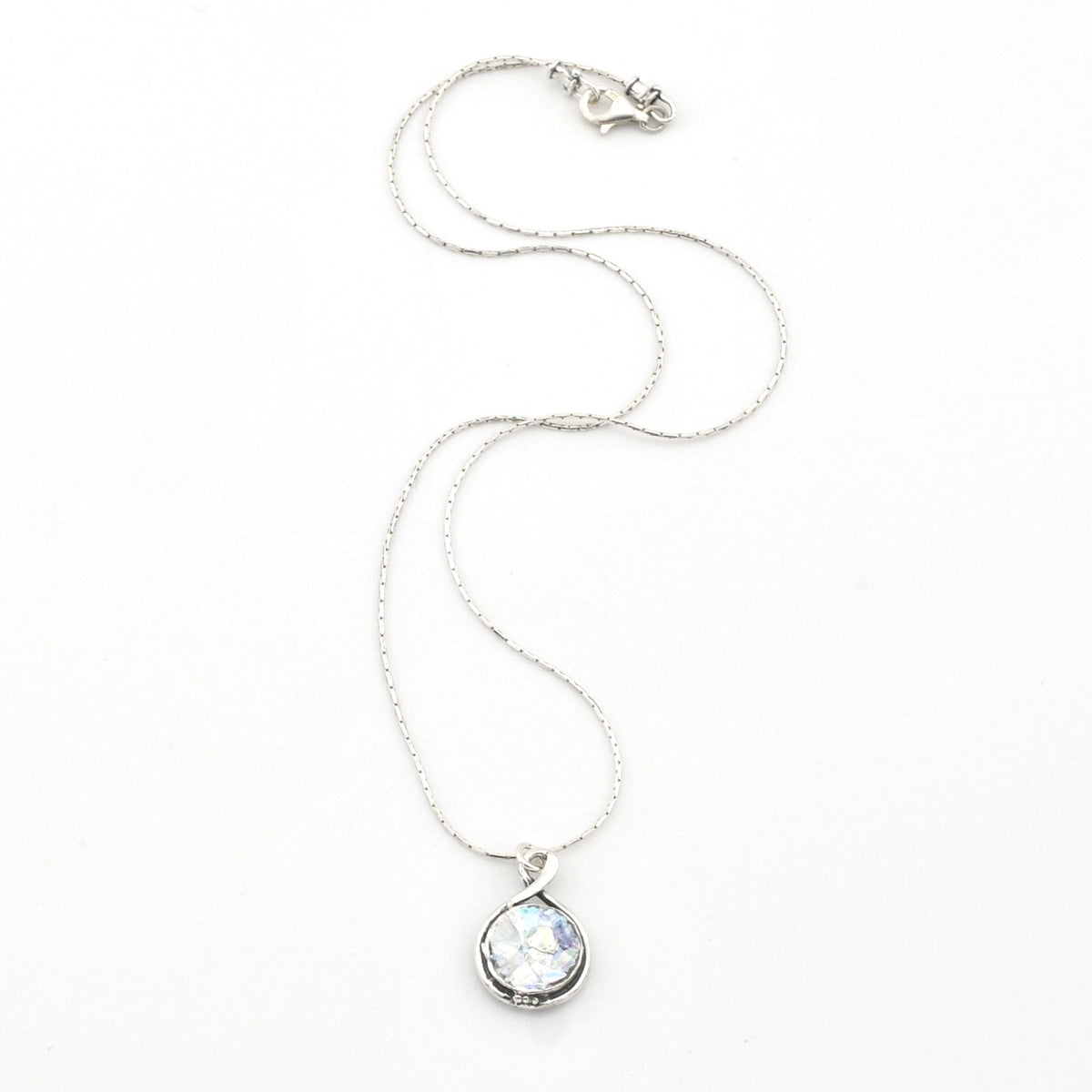 Silver necklace with a teardrop-shaped pendant on a white background