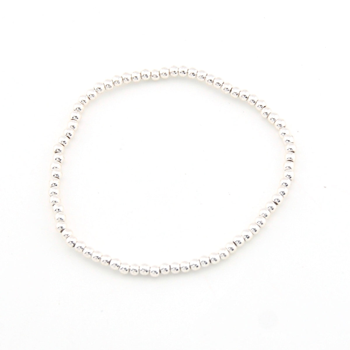 Silver bracelet with small beads on a white background