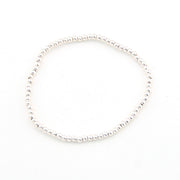 Silver bracelet with small beads on a white background