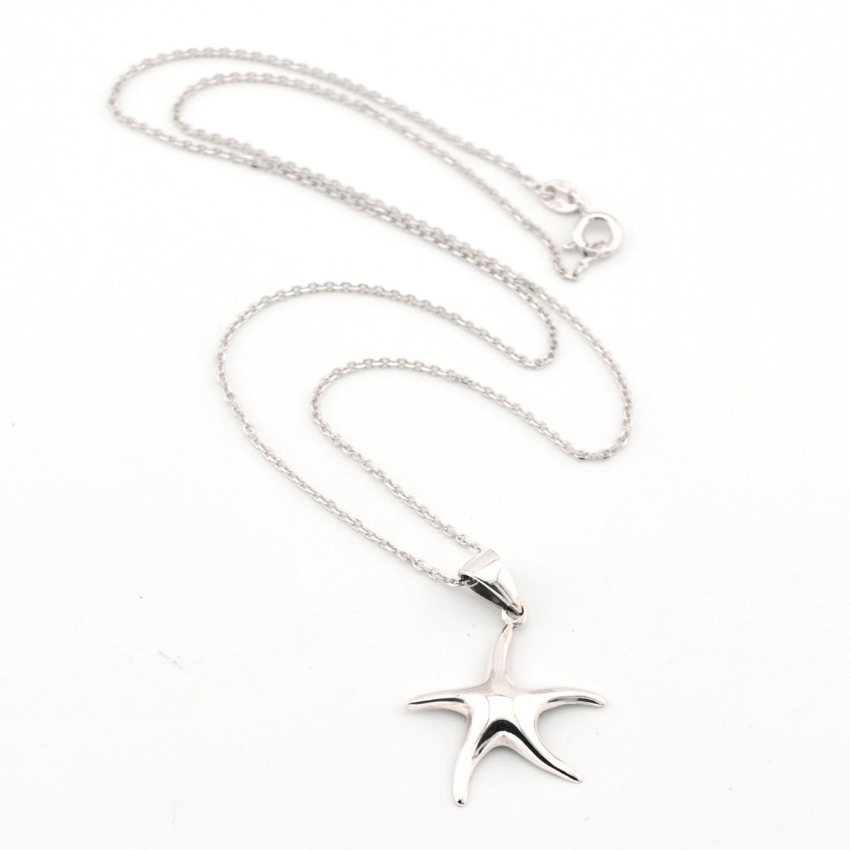 Silver starfish pendant necklace on a white background