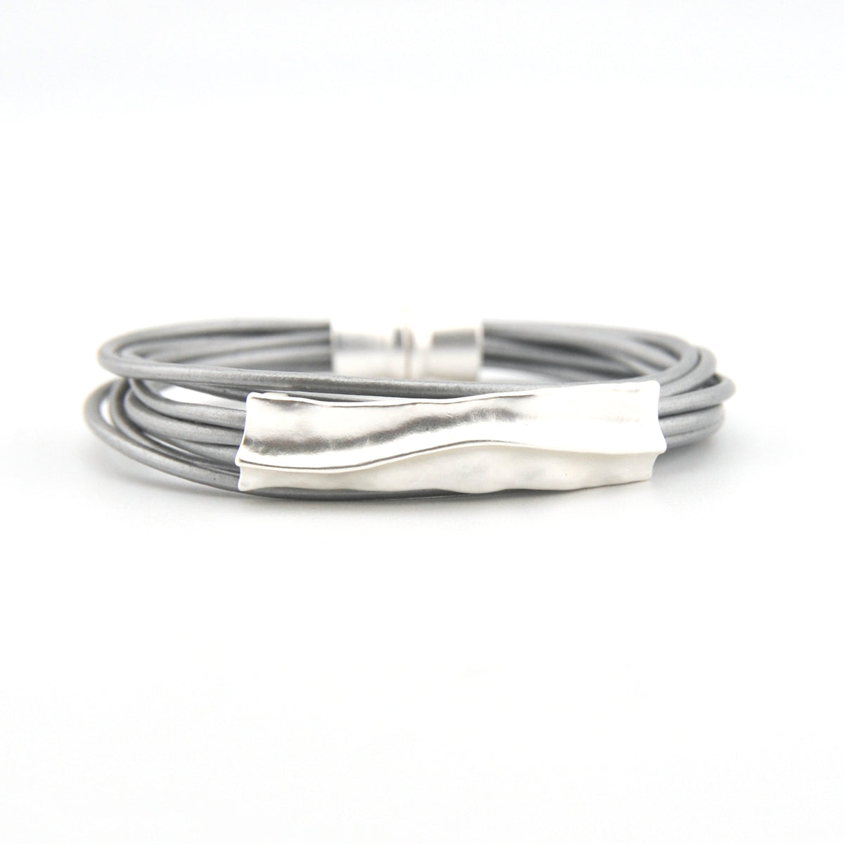 Silver bracelet with a textured clasp on a white background