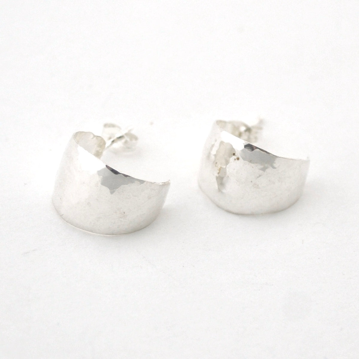 Pair of silver hoop earrings on a white background