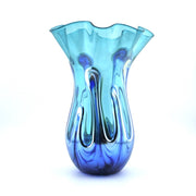 A decorative glass vase with a flared, ruffled rim and a bulbous base, featuring a swirled glass design that transitions from light aqua blue at the top to deep cobalt blue at the bottom, set against a plain white background.