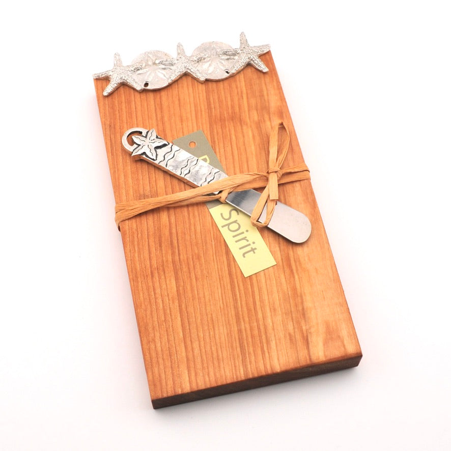 Wooden cutting board with a silver starfish design knife and 'Spirit' tag on a white background