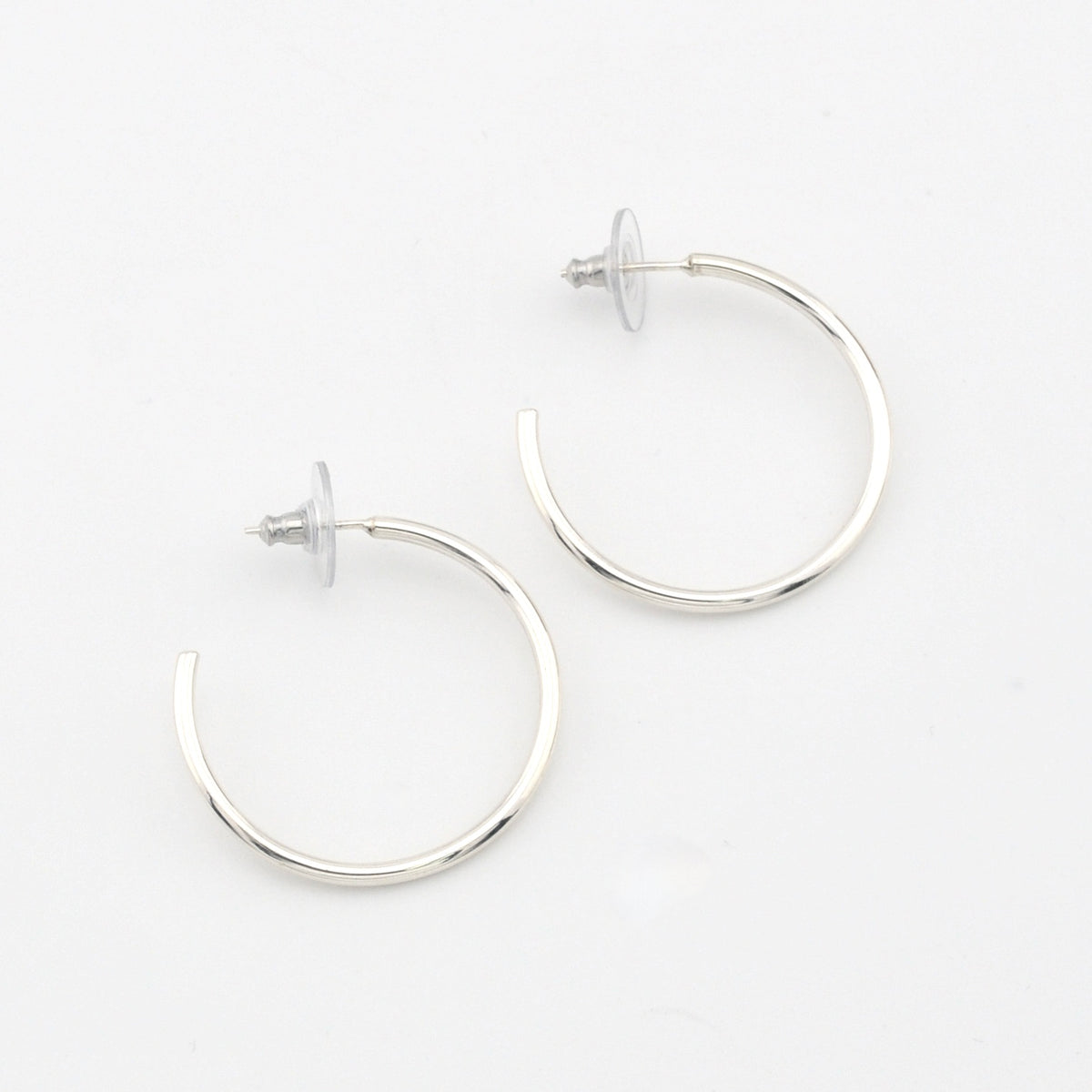 Silver hoop earrings on a white background