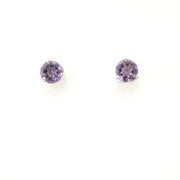 Pair of round purple gemstone earrings on a white background