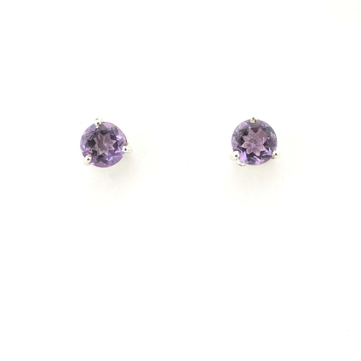 Pair of round purple gemstone earrings on a white background