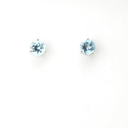 Pair of round blue gemstone earrings on a white background