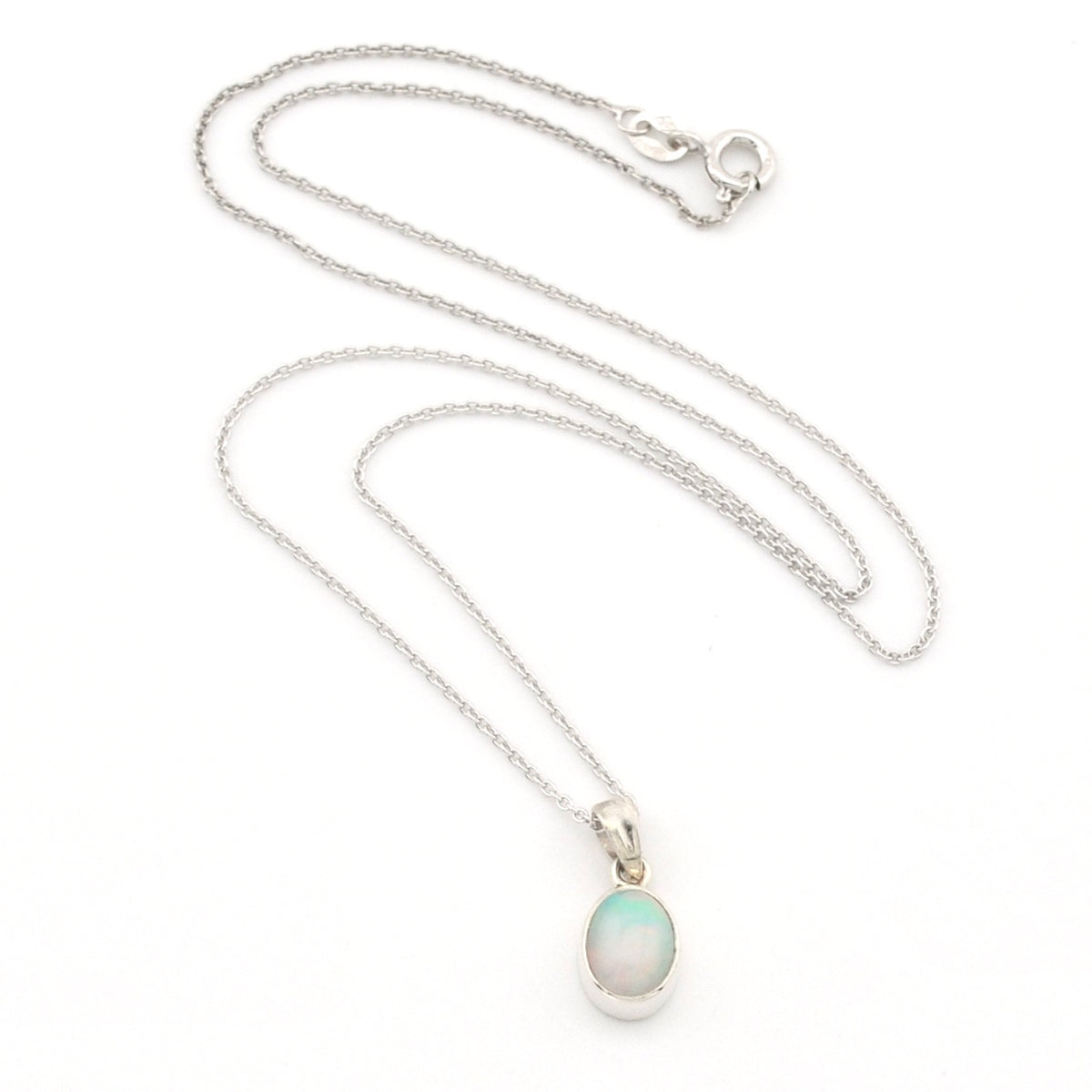 A silver chain necklace with a small oval pendant featuring a milky white stone with a soft green-blue tint, displayed on a clean white background.