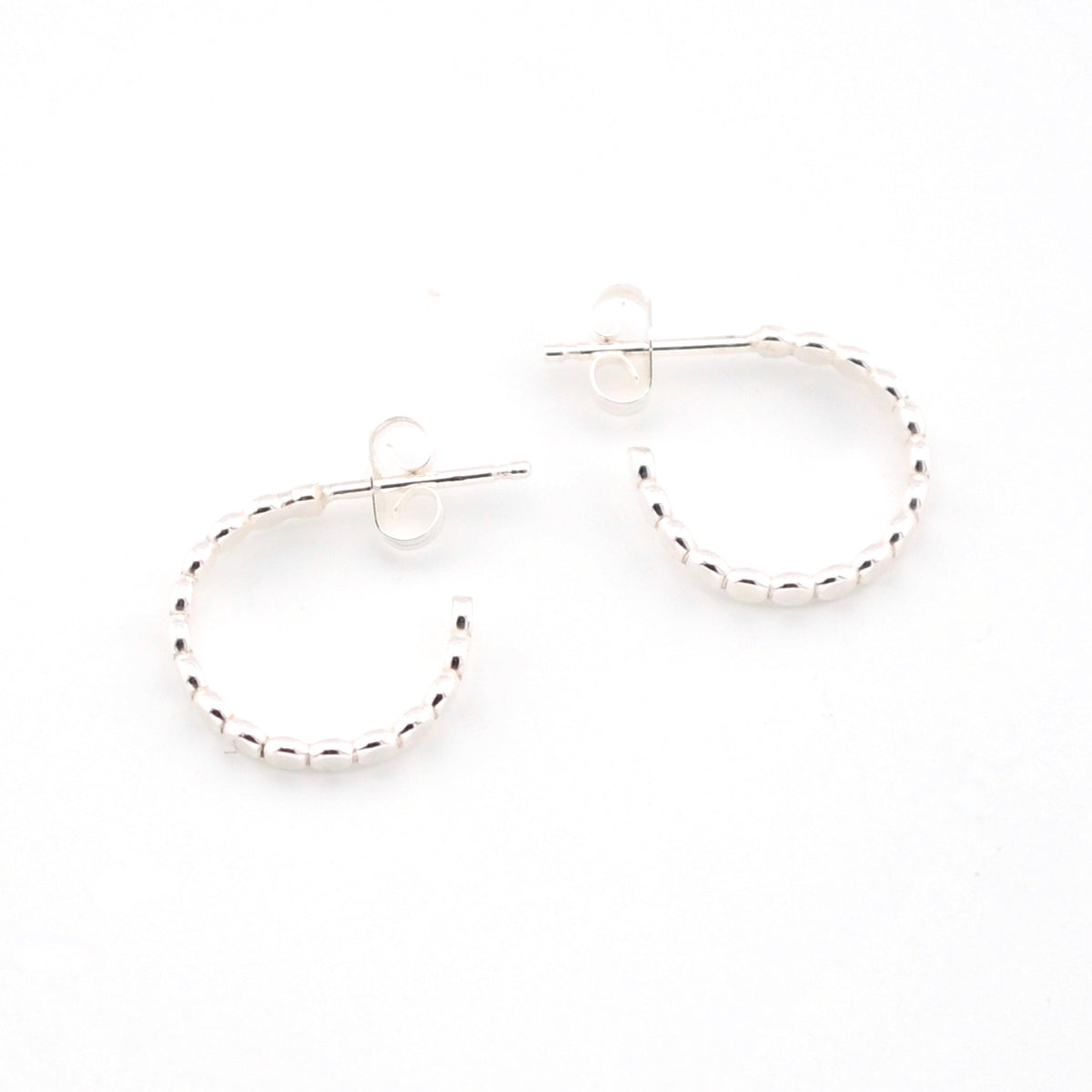 Silver hoop earrings on a white background