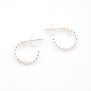 Silver hoop earrings on a white background