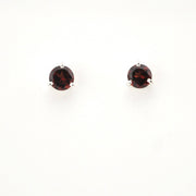 Pair of round gemstone earrings on a white background