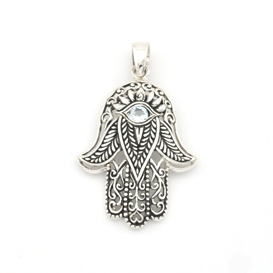 Silver Hamsa hand pendant with intricate designs on a white background