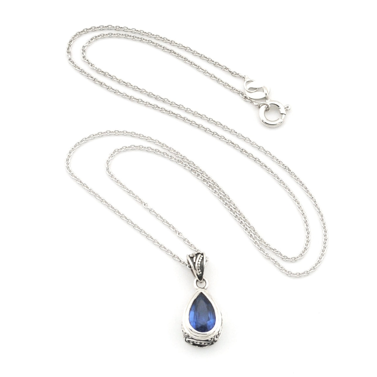 A silver teardrop pendant necklace featuring a deep blue teardrop gemstone, displayed on a clean white background.