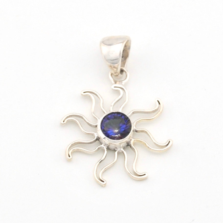Silver sun-shaped pendant with a blue gemstone on a white background