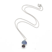 Necklace with a pendant featuring two stones on a white background