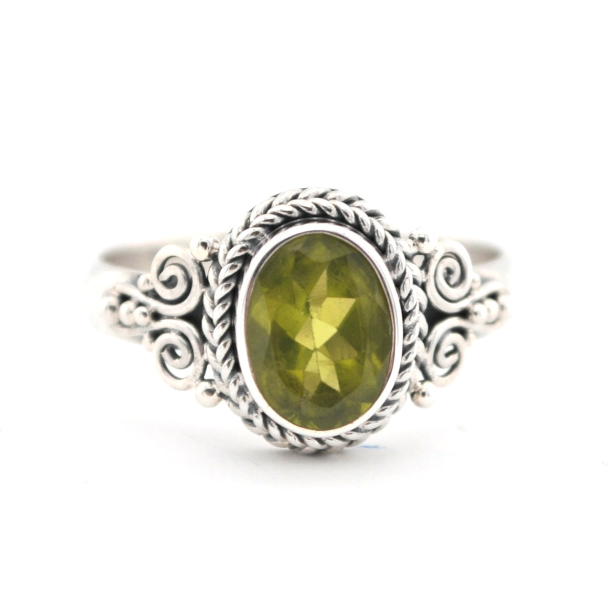Silver ring with a green gemstone on a white background