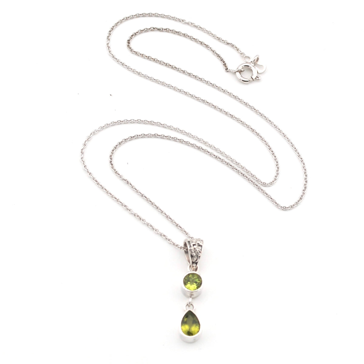 Silver necklace with a 2 green peridot stone pendant on a white background