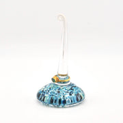 Glass ornament with blue pattern on a white background